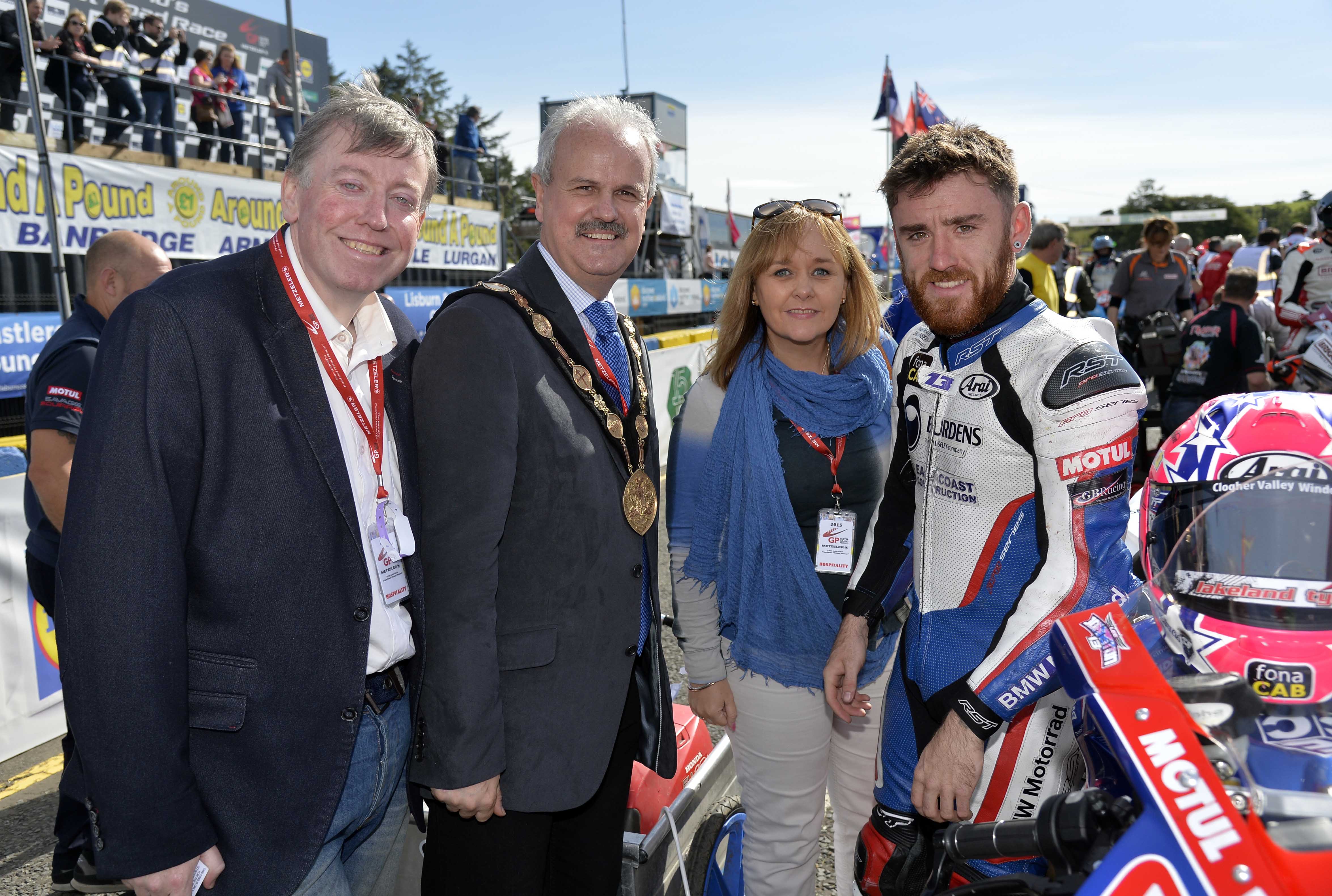 The Mayor of Lisburn & Castlereagh City Council, Councillor Thomas Beckett, Chairman of the Leisure and Community Development Committee, Alderman Paul Porter and Junior Minister at the Office of the First Minister and Deputy First Minister, Michelle McIlveen chat to Northern Ireland’s Lee Johnston on the grid.