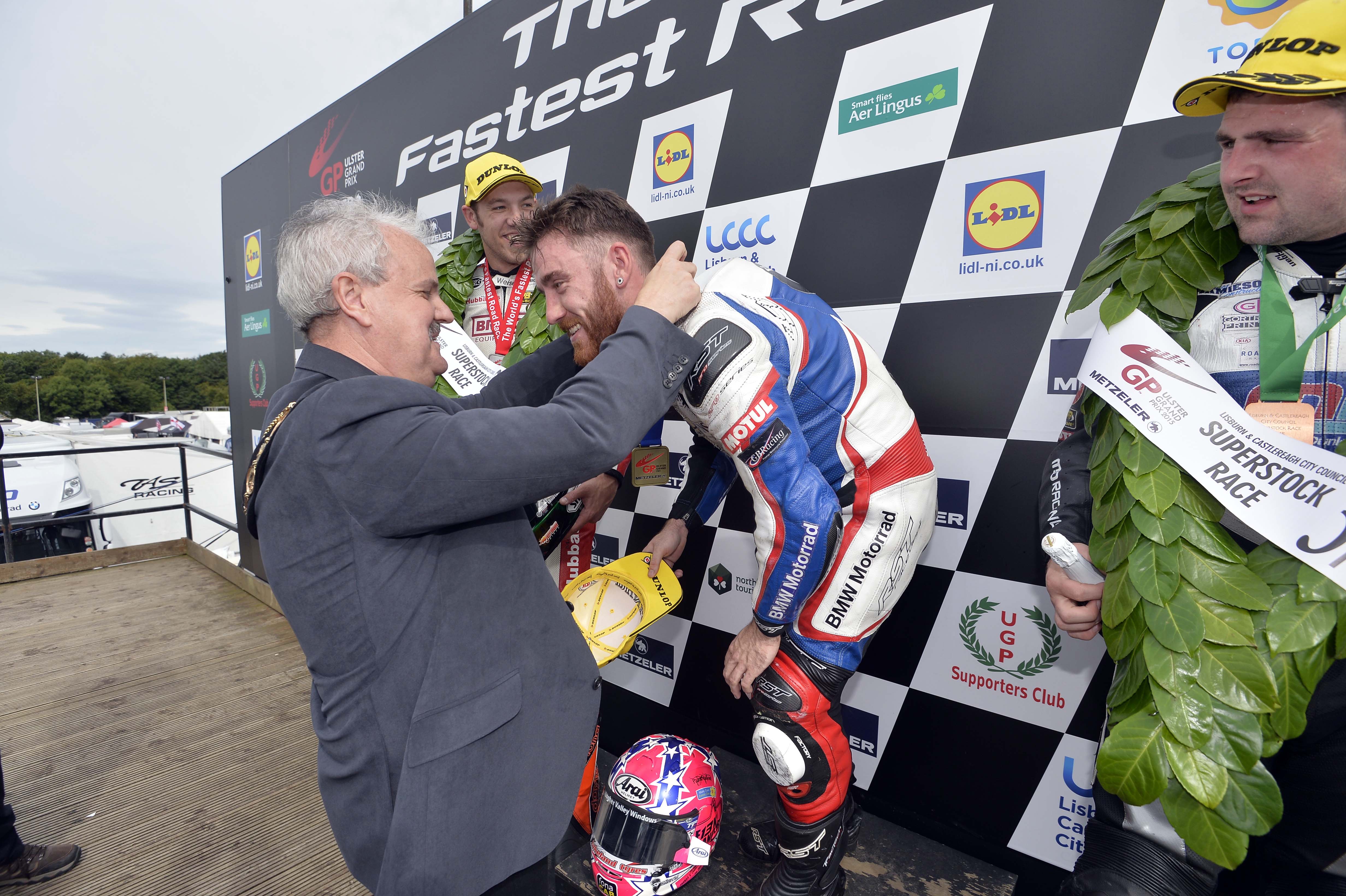 The Mayor of Lisburn & Castlereagh City Council, Councillor Thomas Beckett congratulates Lee Johnston on his first UGP win in the Superstock race.