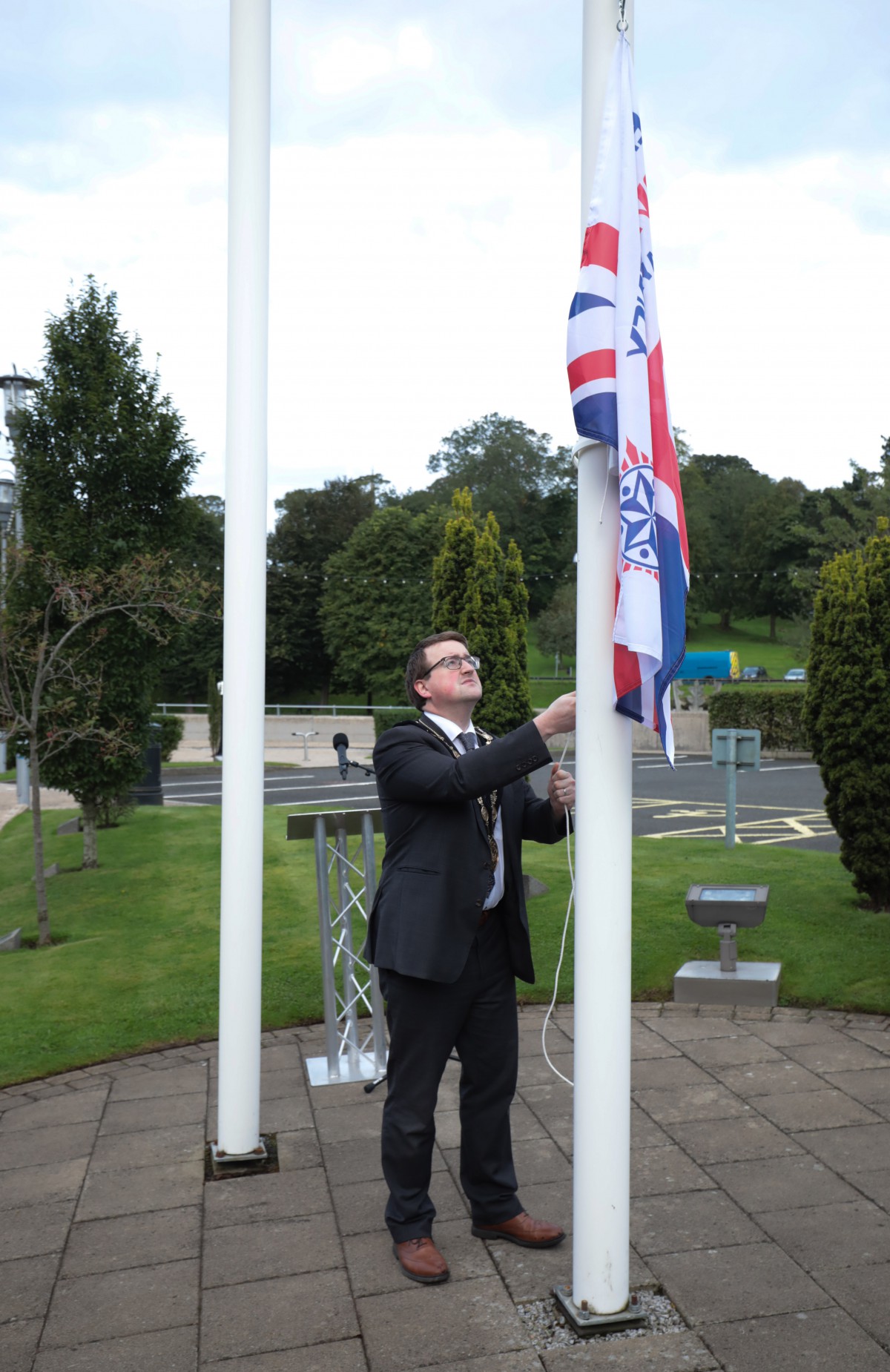 The Mayor, Councillor Nicholas Trimble raising the 999 Emergency Services Flag